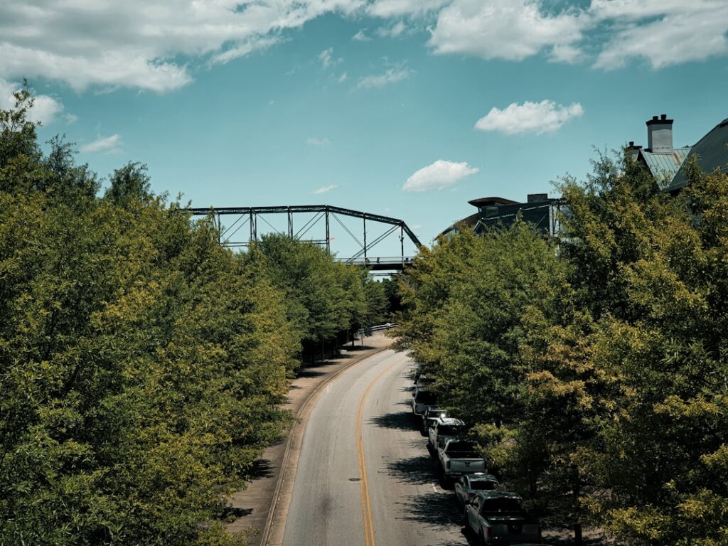 Bright, sunny aerial view of a residential neighborhood in Chattanooga, Tennessee, with the scenic rolling hills in the ba...