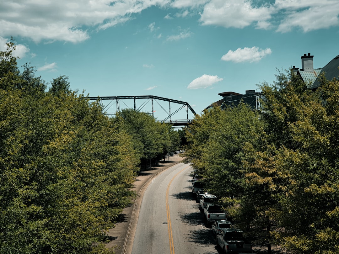 Bright, sunny aerial view of a residential neighborhood in Chattanooga, Tennessee, with the scenic rolling hills in the ba...