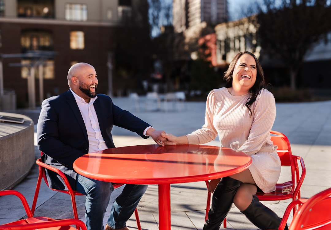 A professional real estate agent shakes hands with a happy client inside a bright, modern home, symbolizing a successful and stress-free sale with a 1% Realtor.