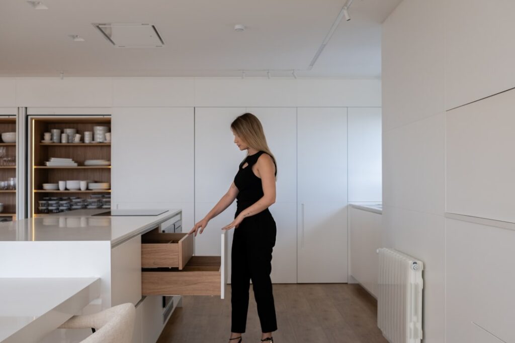 Homeowner and a real estate agent shaking hands in a bright, modern home, symbolizing a successful and fair negotiation of...