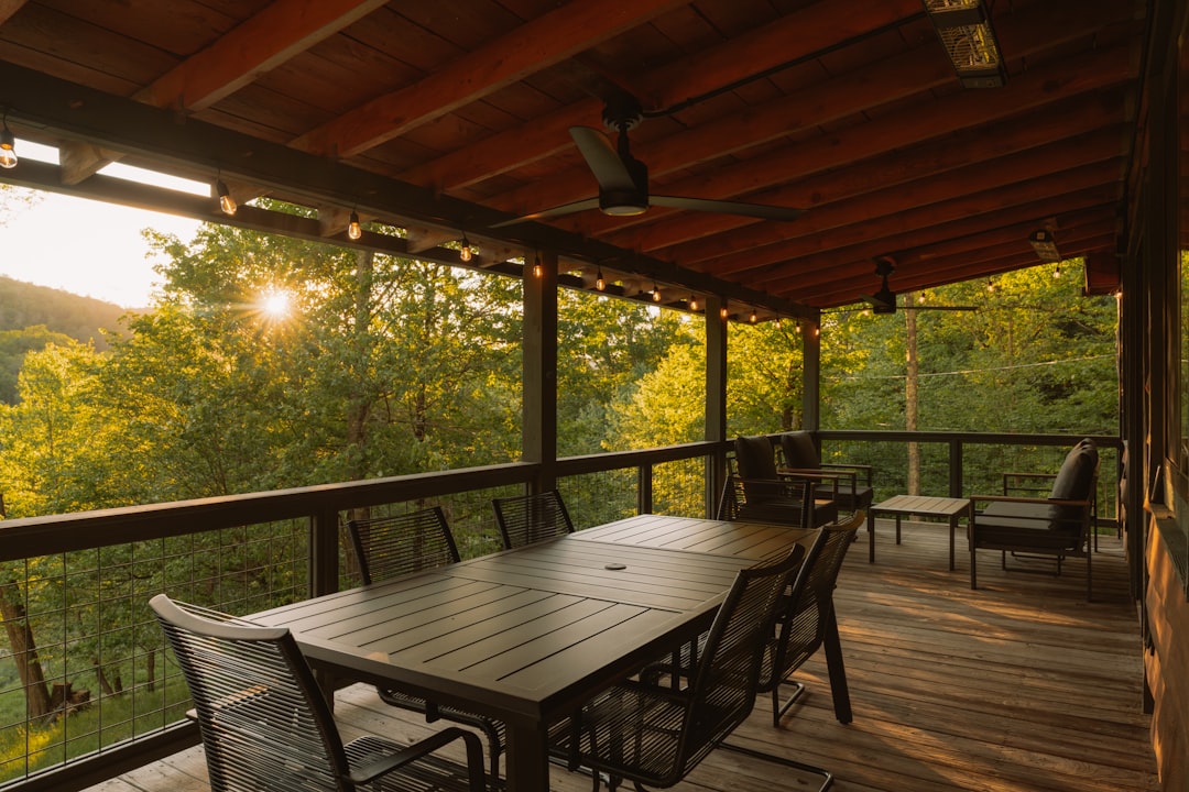 A relaxed couple enjoying coffee on their porch with a beautiful mountain view, showcasing the rewarding Chattanooga lifestyle enabled by smart financial savings.